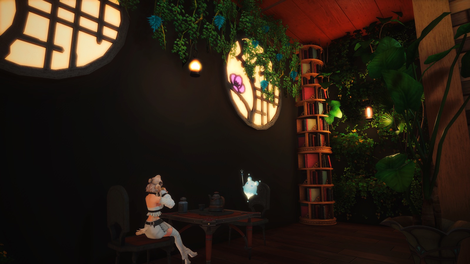 The café's back corner: round paper windows, a book tower, and one guest at a low table